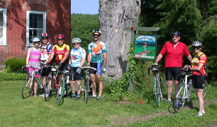 Vermont cycling guests in front of biking sign